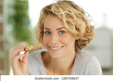 Beautiful Woman Eating Cereal Bar