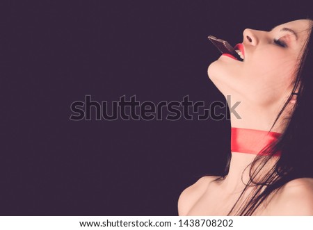 Beautiful woman eating dark chocolate with close eyes. Enjoyment concept. ストックフォト © 