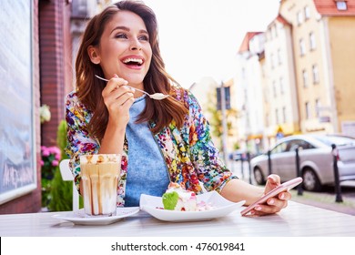 Beautiful Woman Eating Dessert At Outdoors Cafe