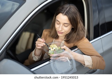 Beautiful Woman Eating Heathy Salad In The Car. Received A Food Order To Go. Have A Quickly Snack On The Lunch Break. 