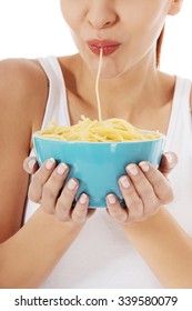 Beautiful Woman Eating Pasta From A Bowl.