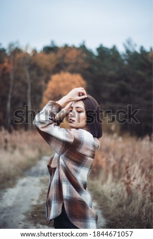 Similar – a girl with long hair and blue eyes in the mountain covering her face with her hair