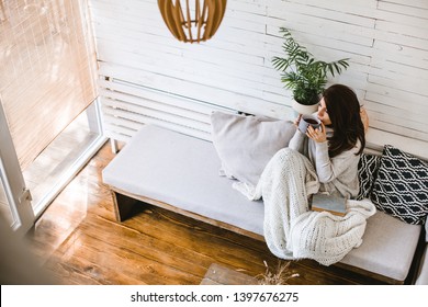 Beautiful Woman Enjoying Cup Of Tea In Her Cosy House