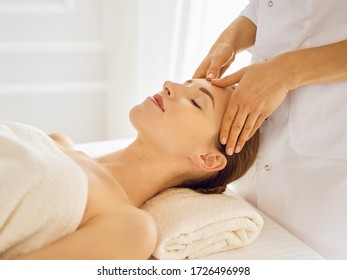 Beautiful woman enjoying facial massage with closed eyes - Shutterstock ID 1726496998