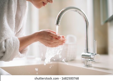 Beautiful Woman Enjoying In Hotel. Young  Happy Women In Bathrobe Wash Her Face.