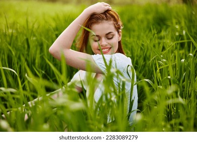 beautiful woman enjoying nature sitting in tall grass - Powered by Shutterstock