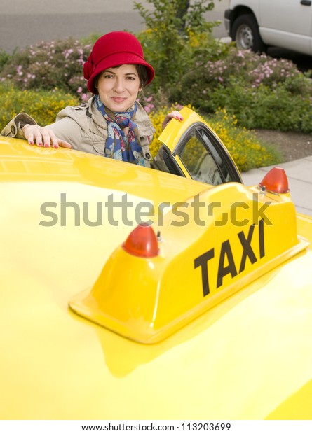 Beautiful woman enters a\
yellow taxi