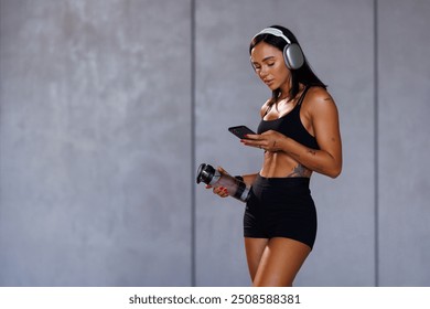 Beautiful woman exercising fitness at home and talking to mobile phone, Home interior, Fitness mat. - Powered by Shutterstock