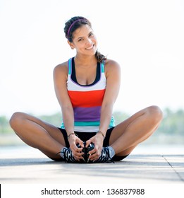 Beautiful woman exercising outdoors and looking very happy - Powered by Shutterstock