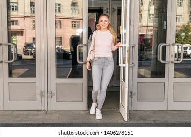 Beautiful Woman Exit The Building Through A Glass Door