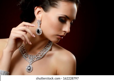 The beautiful woman in expensive pendant close-up