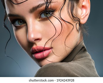  Beautiful  woman Face with a bang. Model looking at camera. Sexy woman looks at camera. Closeup portrait of a beautiful young fashion woman with glamour makeup posing at studio.