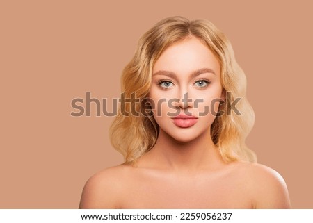 Beautiful Woman Face close up studio on peach background. Makeup. Beauty Portrait of female Face with smokey eyes and arrows, beautiful natural plump lips. Isolated                      