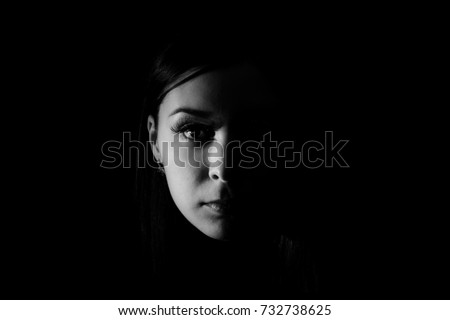 Beautiful woman face in the darkness