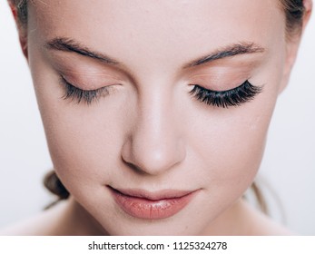 Beautiful woman face with eyelashes lashes extension before and after beauty healthy skin natural makeup closed eyes