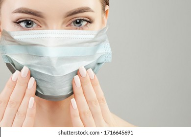 Beautiful Woman In A Face Mask Showing Manicured Nails