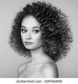Beautiful woman face. Perfect makeup. Beauty fashion.  Cosmetic. Eyeshadow. Elegant afro curly hairstyle. Black and white photo.