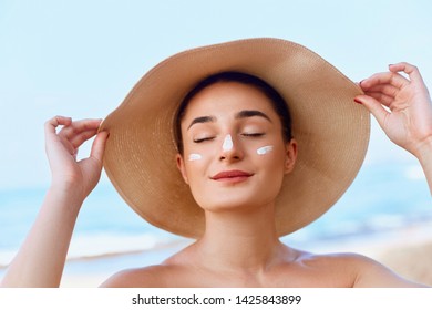 Beautiful Woman Face. Skin Care Concept. Suncream. Suntan Lotion Beautiful Woman Applying On Beautiful On Face. Sunscreen Solar Cream. Sun Protection.