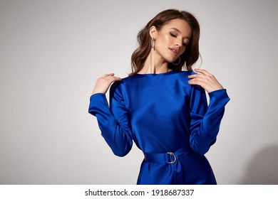 Beautiful woman fashion model makeup brunette hair perfect body shape tanned skin wear clothes summer collection organic mini blue silk dress stylish sandals shoes, accessory romantic date walk.
