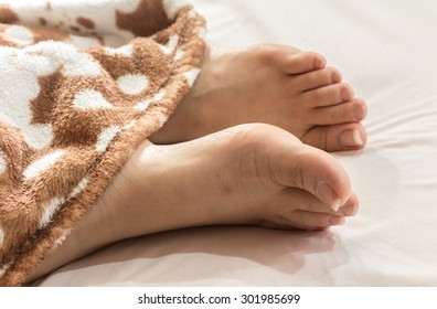 Beautiful Woman Feet On The Bed