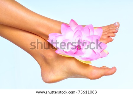 Beautiful woman feet. Over blue background. Body care.
