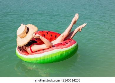 Beautiful Woman Floating On Inflatable Ring In Blue Lake Water Summer Sunny Day