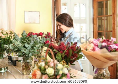 Similar – Woman arranges flower bouquet with roses in vase