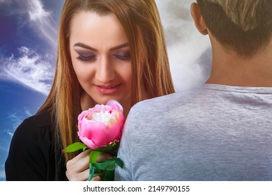 A beautiful woman with a flower in her hand with her partner.