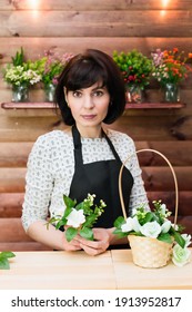 Beautiful Woman Flower Shop Clerk Behind The Counter.