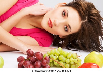 Beautiful woman with fresh fruits