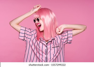 Beautiful Woman Gallows On A Pink Background Fashionable Shirt And A Wig On Her Head