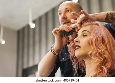 Beautiful woman getting haircut by hairdresser in the beauty salon. - Shutterstock ID 405719401