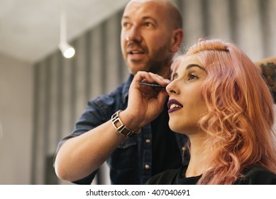 Beautiful woman getting haircut by hairdresser in the beauty salon. - Powered by Shutterstock