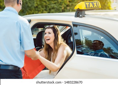 Beautiful Woman Getting Out Of Taxi And The Driver Helping Her