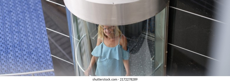 Beautiful Woman In The Glass Elevator Of The Building