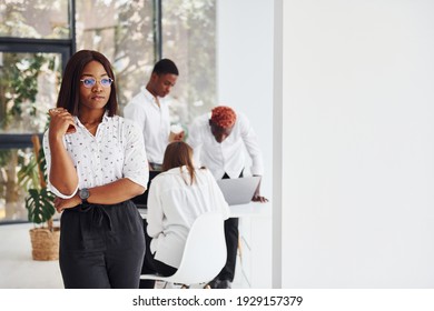 Beautiful Woman In Glasses In Front Of Her Colleagues. Group Of African American Business People Working In Office Together.