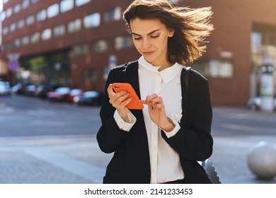 Beautiful Woman Going To Work With Mobile Phone, Business Woman Walking Near Office Building. Portrait Of Successful Business Woman.