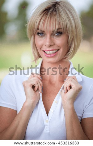 Beautiful woman golf caddy on course wide angle vertical shot