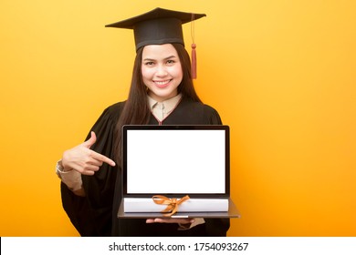 Beautiful Woman In Graduation Gown Is Holding Laptop Mockup 