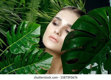 Beautiful woman green leaves palm jungle nature charm
