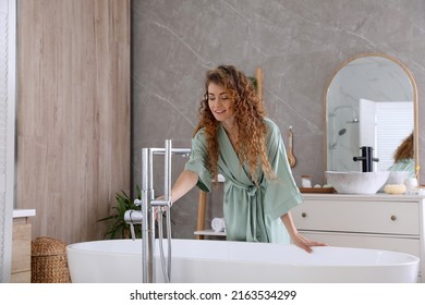 Beautiful Woman In Green Silk Robe Near Bathtub At Home