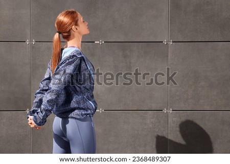 Beautiful woman in gym clothes doing exercises on street, space for text Stock foto © 
