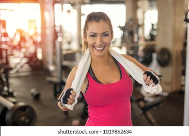 Beautiful Woman At The Gym With Towel Smiling At The Camera