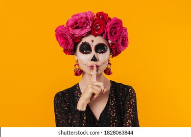 Beautiful Woman In Halloween Makeup And Flower Wreath Making Silence Gesture Isolated Over Yellow Wall