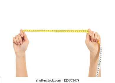 Beautiful woman hand stretching a measure tape on a white isolated background - Shutterstock ID 125703479