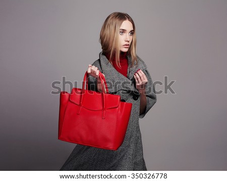 beautiful Woman with Handbag.Beauty Fashion Girl in topcoat.winter Shopping