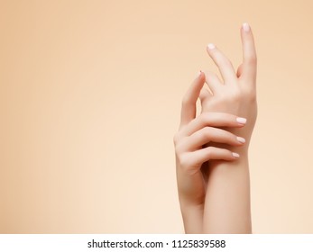 Beautiful Woman Hands. Female Hands Applying Cream, Lotion. Spa and Manicure concept. Female hands with french manicure. Soft skin, skincare concept. Hand Skin Care. - Shutterstock ID 1125839588