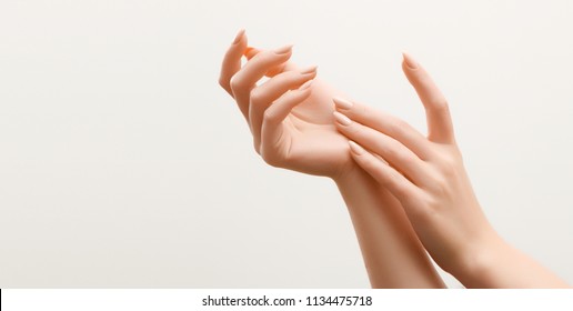 Beautiful Woman Hands. Female Hands Applying Cream, Lotion. Spa and Manicure concept. Female hands with french manicure. Soft skin, skincare concept. Hand Skin Care.