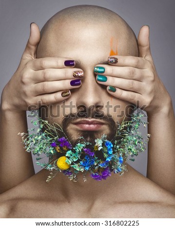Beautiful woman hands with nail art and man with colorful makeup on white background, flowers on man beard