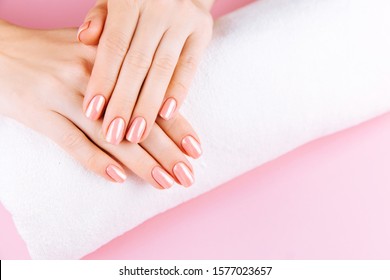 Beautiful Woman Hands . Spa and Manicure concept. Female hands with pink manicure. Soft skin skincare concept. Beauty nails. Over beige background